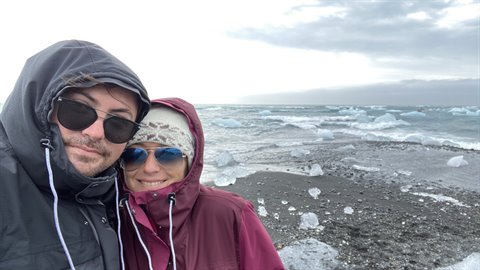 Noi due con giacche antivento sulla spiaggia di ghiacci flottanti di Jokulsarlon