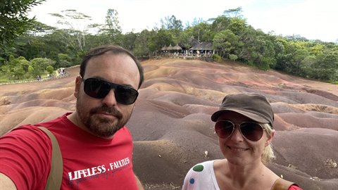 Couple takes selfie before colorful volcanic earth, travel diary, natural daylight