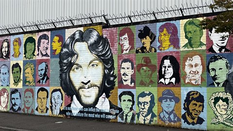 Colourful mural with painted portraits on an urban wall, daylight, travel shot