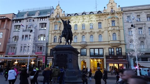 Equestrian statue of Ban Jelačić in Zagreb, crowded square with festive lights