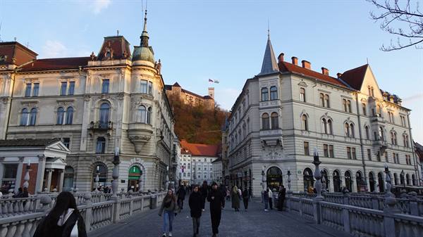 Ljubljana Triple Bridge with pedestrians and castle on the hill
