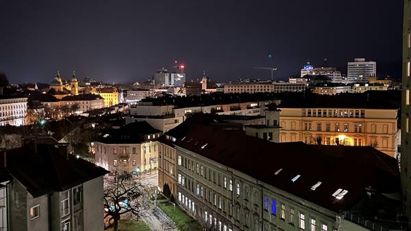 Ljubljana rooftops and historic buildings lit up at night