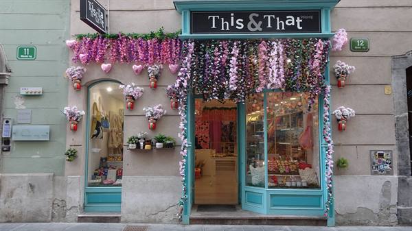 This & That shop with turquoise frames and cascading flower decorations