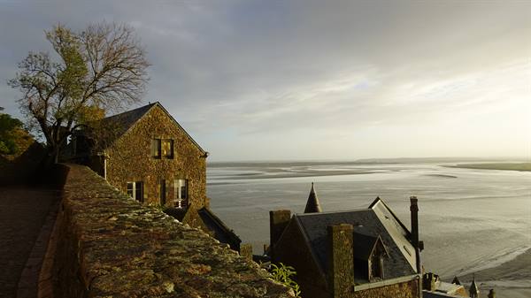 From the top of the Mount, the calm sea embraces the old stone houses.