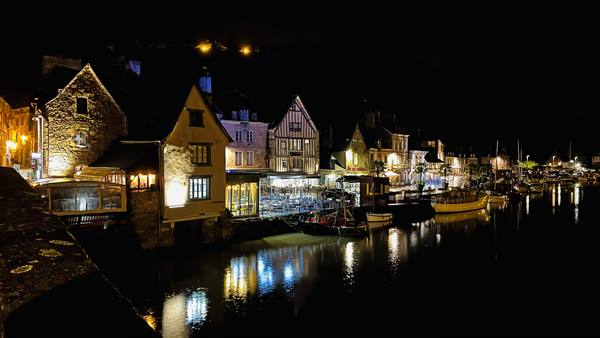 The sleeping harbour reflects warm lights in the quiet night.