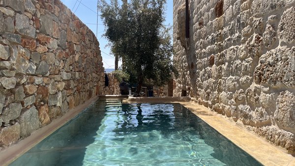 A dip into calm, among stone walls and blue sky.
