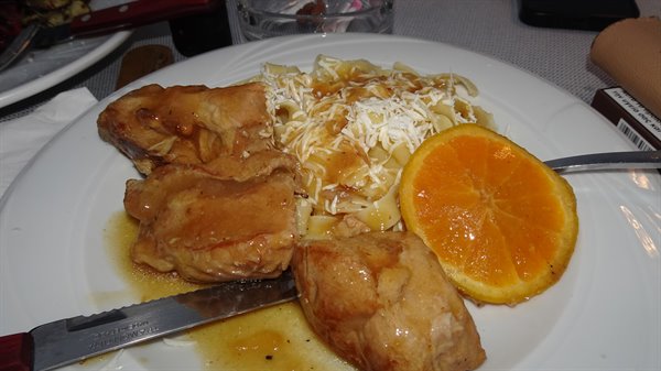 Lunch on the road: chicken, tagliatelle and a slice of sunny orange.