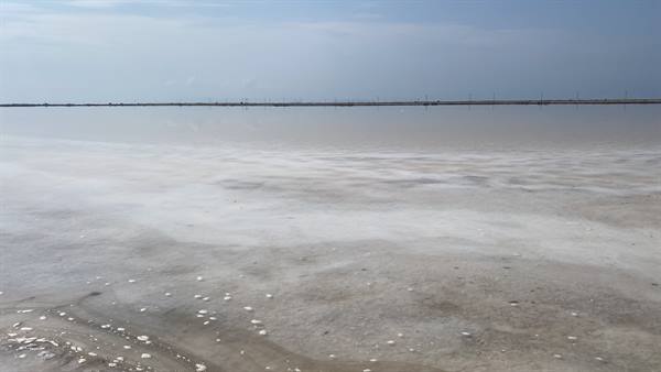Where the sky mirrors in the salt water, time has stood still.