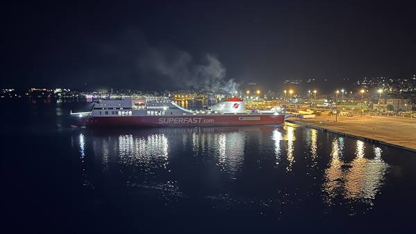 The ferry waits for us under the lights of the night, ready to set sail.