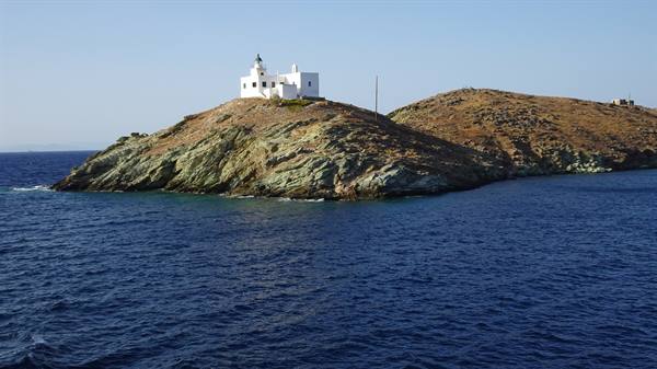 The white lighthouse watches over the blue, and we look on in silence.