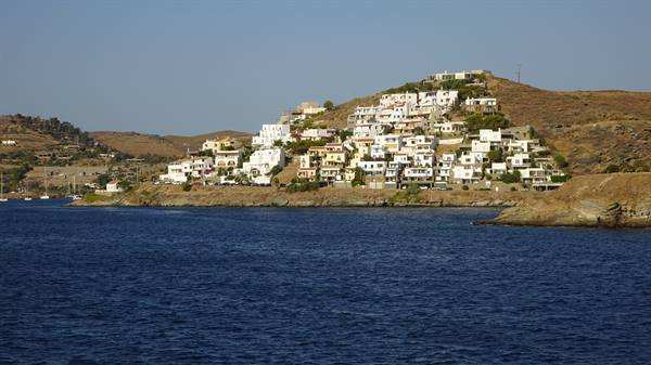 White houses embracing the hill, and the sea whispering summer stories.