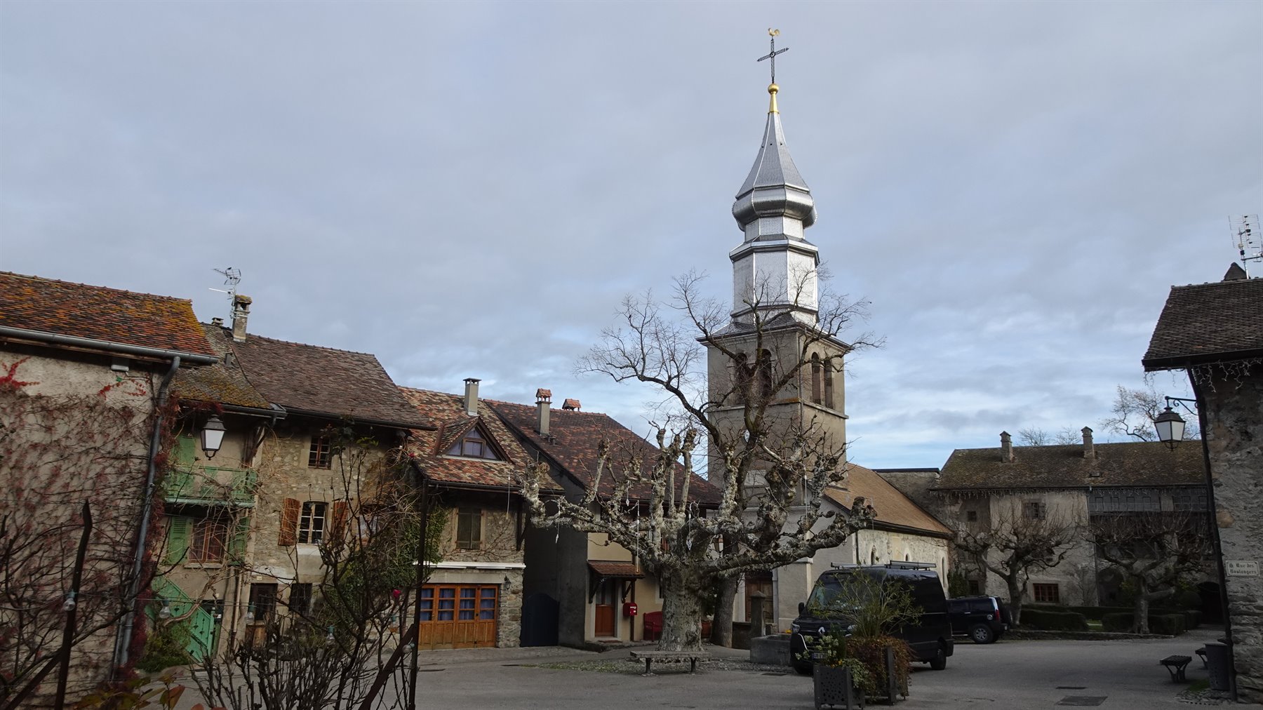 Campanile a guglia argentata della chiesa di Yvoire tra vecchie case in pietra