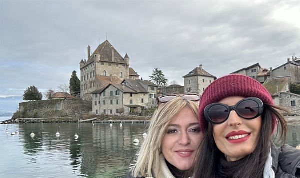 Selfie in front of Yvoire castle on the lake, stone houses and grey sky