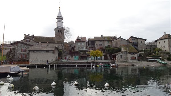 Yvoire: stone village with onion-domed bell tower over the lake, moored boats