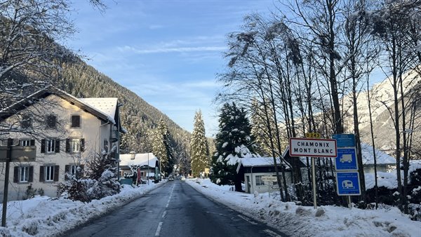 Snowy road in Chamonix, houses and fir trees covered in snow
