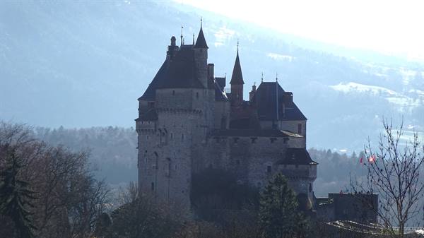 Château de Menthon-Saint-Bernard, medieval towers in mist above Lake Annecy