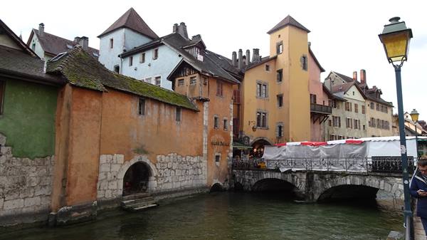 Colorful houses and stone bridge over Annecy canal
