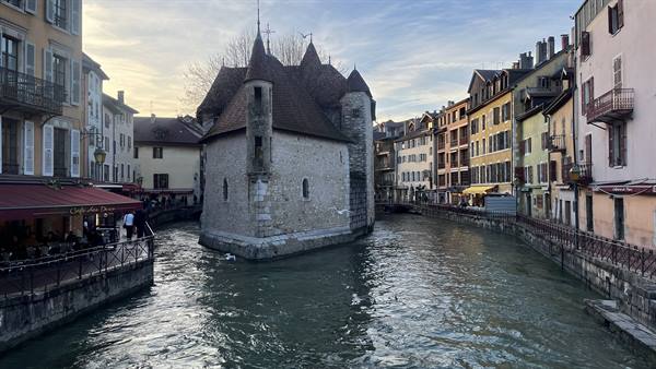Palais de l'Isle on the canal, Annecy, evening lights on cafés