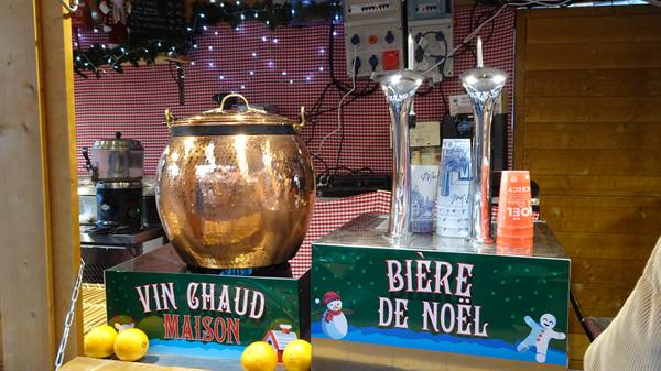Christmas market stall with copper mulled wine pot and Christmas beer