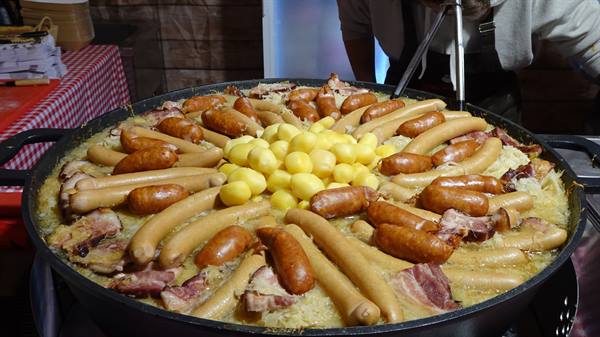 Giant choucroute pan with sausages, potatoes and bacon, served at Yvoire market