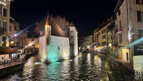 Illuminated Palais de l'Isle on the canal at night, Annecy