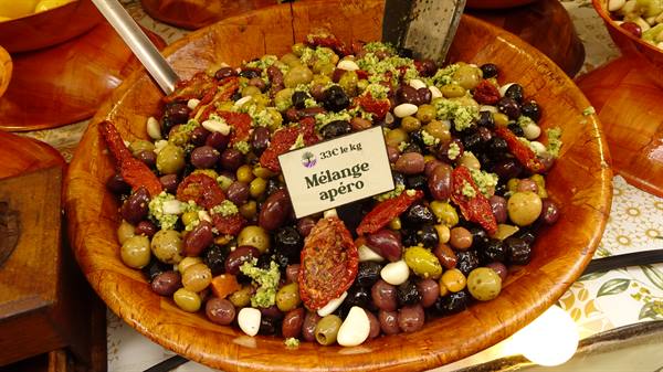 Wooden bowl of mixed olives and sun-dried tomatoes, Yvoire market