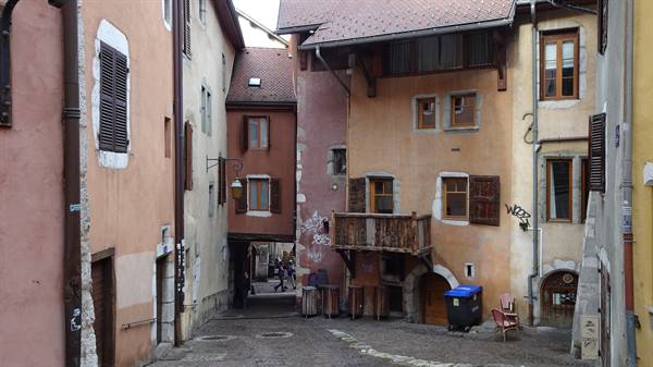 Cobbled alley between medieval stone and ochre plaster houses, Annecy