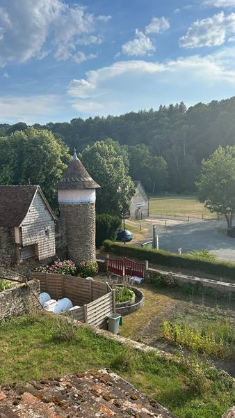 Stone tower with conical roof and garden in Saint Ceneri le Gerai