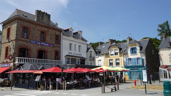 Bar Le Galion and cafés with red umbrellas in Cancale square