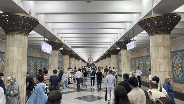 Metropolitana di Tashkent, colonne decorate e viaggiatori tra luce bianca