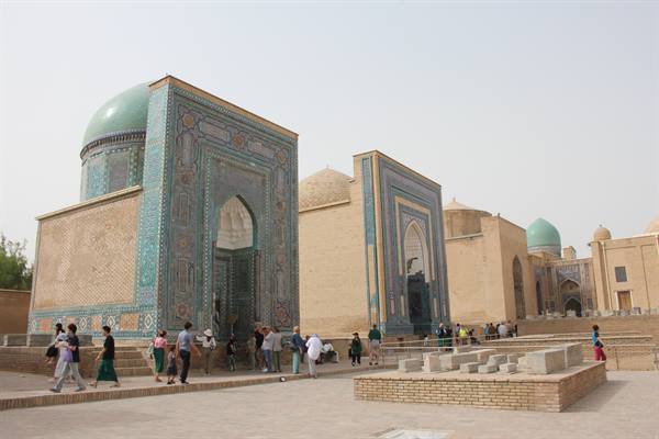 Mausolei in maiolica verde e turchese, turisti passeggiano tra le tombe di Shah-i-Zinda, Samarcanda