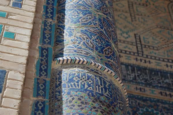 Colonna rivestita di maioliche blu a Samarcanda, luce solare intensa