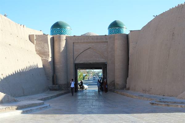 Porta delle mura di mattoni di Khiva con due cupole verdi