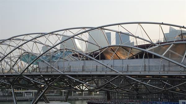 The Helix Bridge in Singapore, intertwined steel structure over the bay