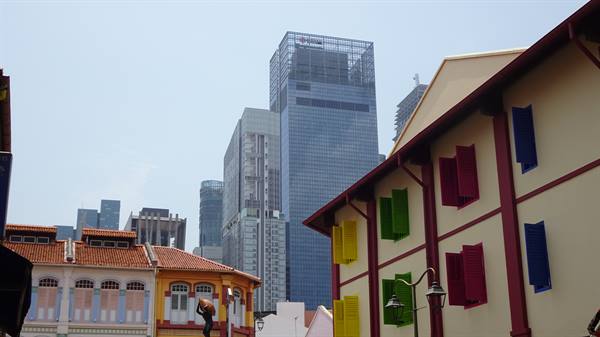 Shophouses with colorful shutters and glass skyscrapers in Chinatown