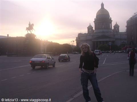 Girl posing on the square with equestrian statue and golden dome, Saint Petersburg