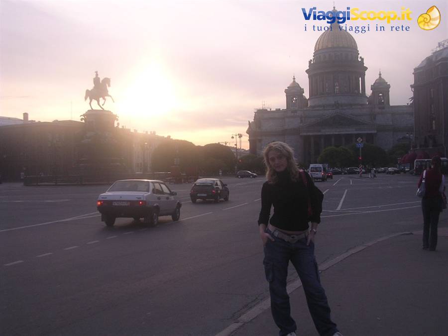 Girl posing on the square with equestrian statue and golden dome, Saint Petersburg