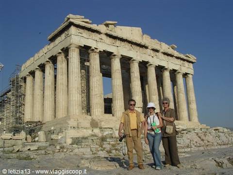 Three tourists pose in front of the Parthenon on the Athens Acropolis