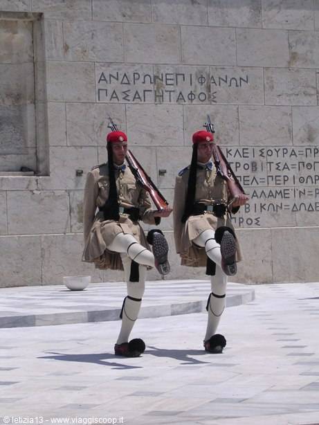 Evzones guards in traditional dress march at the Unknown Soldier monument in Athens