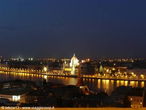 Budapest Parliament illuminated, reflecting in the Danube at night