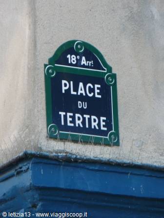 Green enamel street sign reading Place du Tertre on a wall in Montmartre