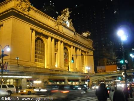 Grand Central Terminal lit up at night with traffic and pedestrians, New York