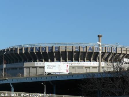 Yankee Stadium seen from the highway, daylight, bare trees