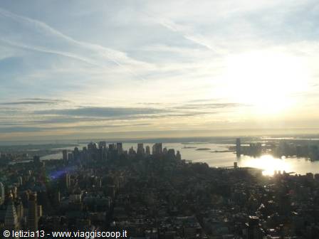 Manhattan skyscrapers and East River glowing under sunlight, New York