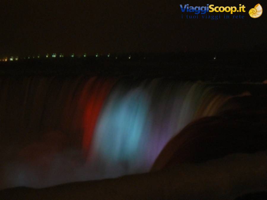 Niagara Falls at night lit by colored lights