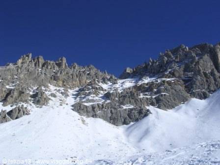 Snowy limestone ridges of Gran Sasso under a clear blue sky