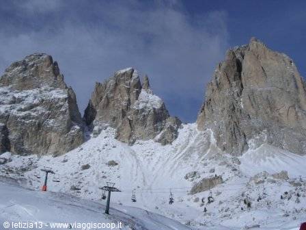 chairlift beneath the snowy Dolomite peaks of the Sella group