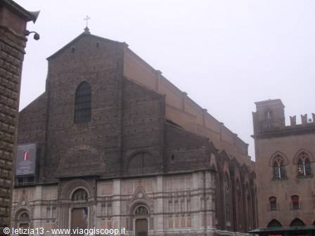 Brick and marble facade of San Petronio in Bologna under fog