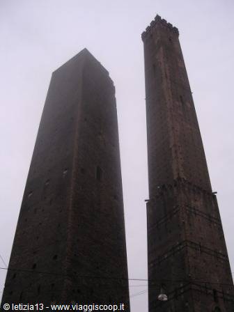 Bologna's Two Towers, Garisenda and Asinelli, dark brick against grey sky