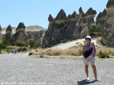 Tourist posing among fairy chimneys in Göreme, Cappadocia